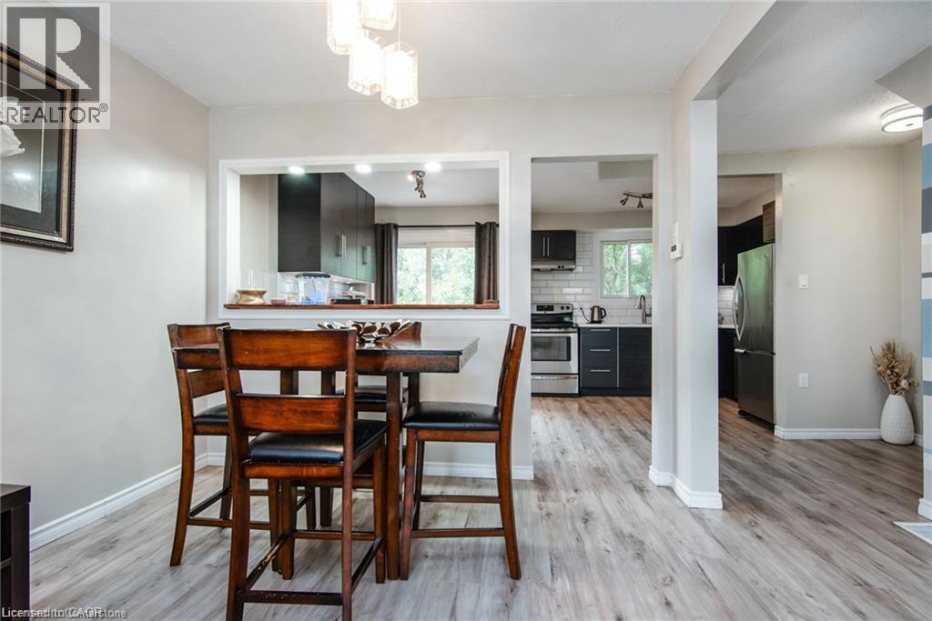 80 OLD COUNTRY Drive Unit# 14=Dining area with baseboards, a notable chandelier, and light wood-type flooring