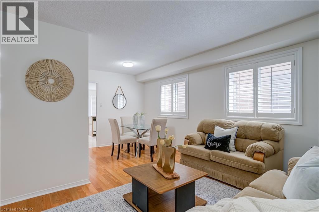 61 CEDARWOOD Crescent=Living room with light wood finished floors and a textured ceiling