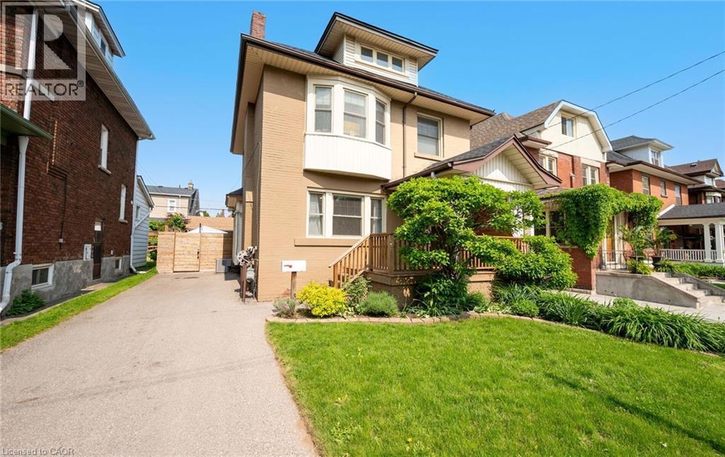 124 EASTBOURNE Avenue=View of front of house with a residential view, a front lawn, a chimney, and driveway