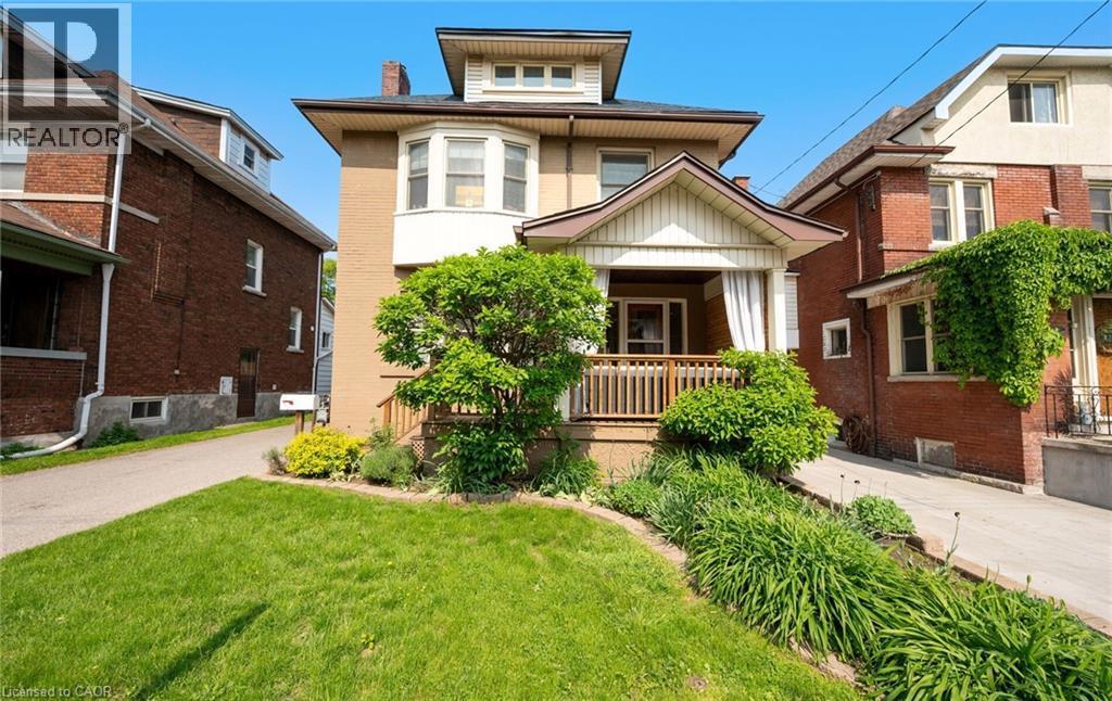 124 EASTBOURNE Avenue=Traditional style home featuring a front lawn, a porch, and a chimney