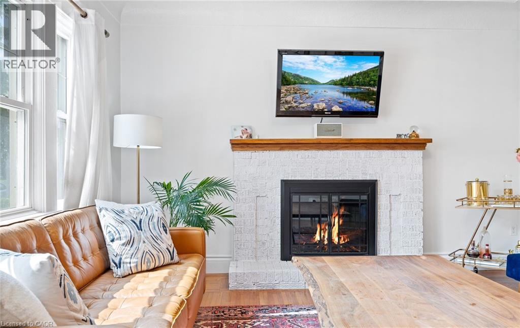 124 EASTBOURNE Avenue=Living room featuring plenty of natural light, a fireplace, and wood finished floors
