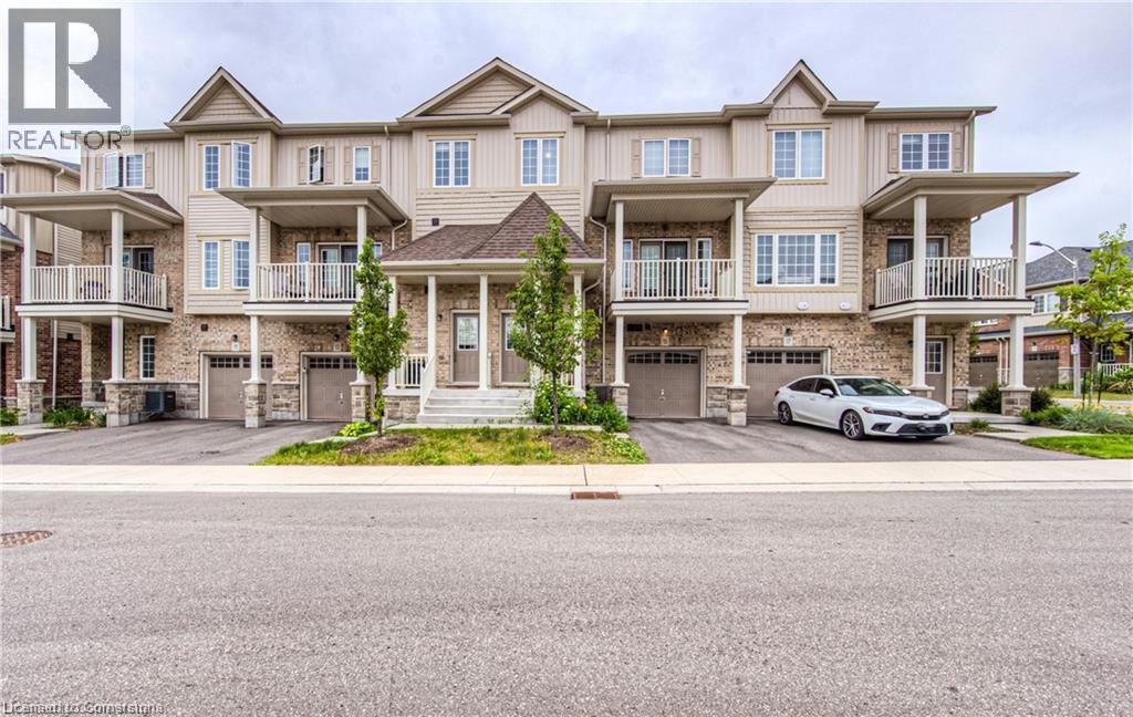 15 DEWBERRY Drive=Craftsman-style house featuring an attached garage, driveway, and a balcony