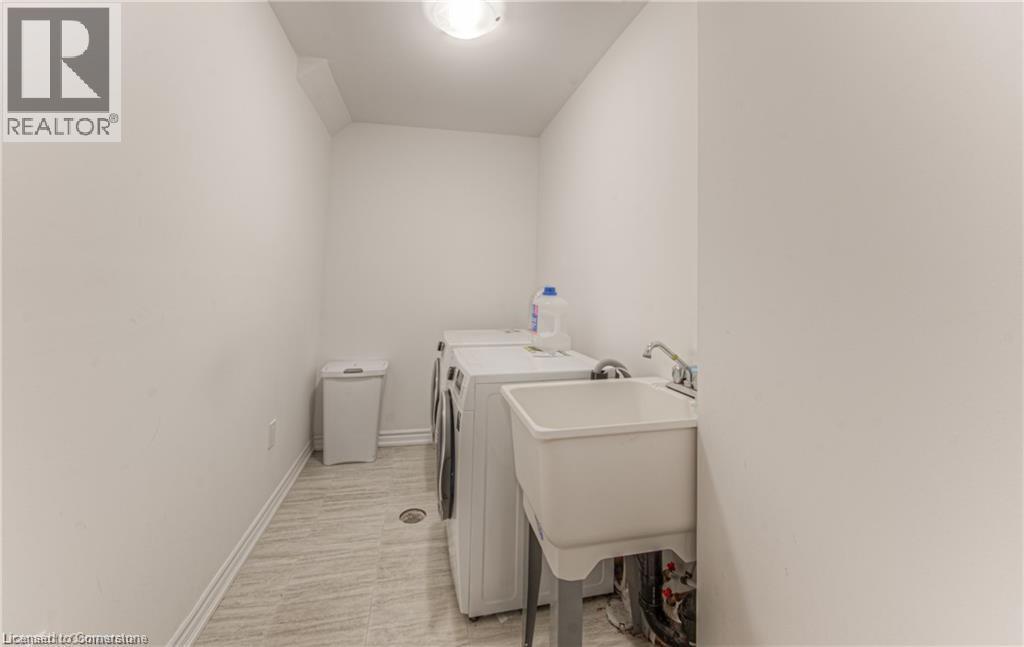 15 DEWBERRY Drive=Laundry area featuring washer and clothes dryer and baseboards