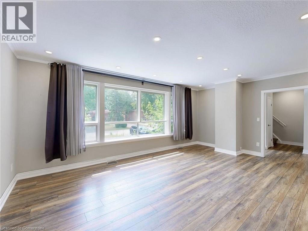 1821 CHRISTOPHER Road=Empty room with ornamental molding, wood finished floors, recessed lighting, and stairway