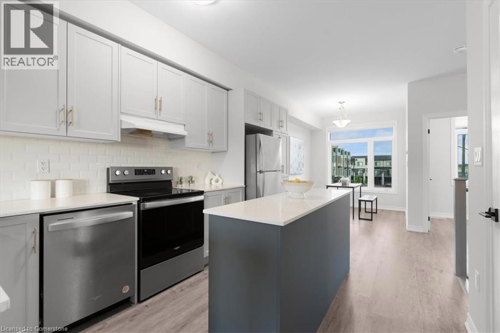 Kitchen with appliances with stainless steel finishes, light wood finished floors, a kitchen island, backsplash, and under cabinet range hood