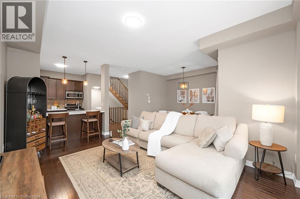 215 DUNDAS Street E Unit# 29=Living room with dark wood-style floors and baseboards