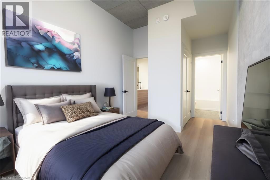 24 AUGUSTA Street Unit# 208=Bedroom featuring light wood-type flooring and connected bathroom