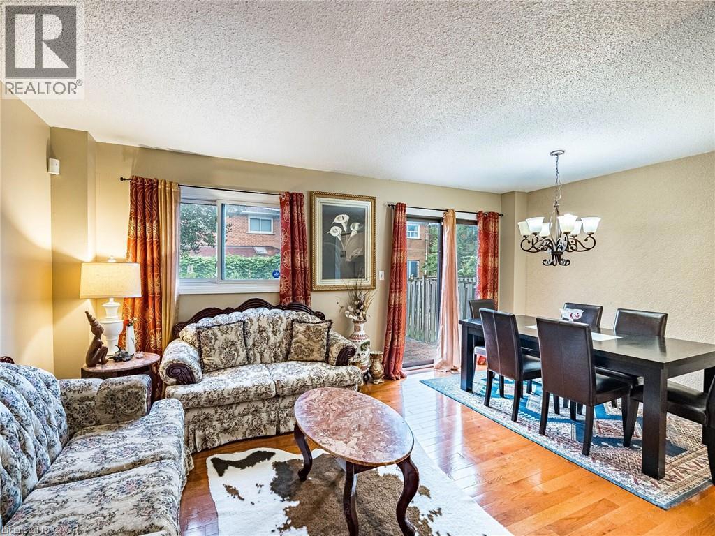 69 NEW SEABURY Drive=Living room featuring a textured ceiling, wood finished floors, and a chandelier
