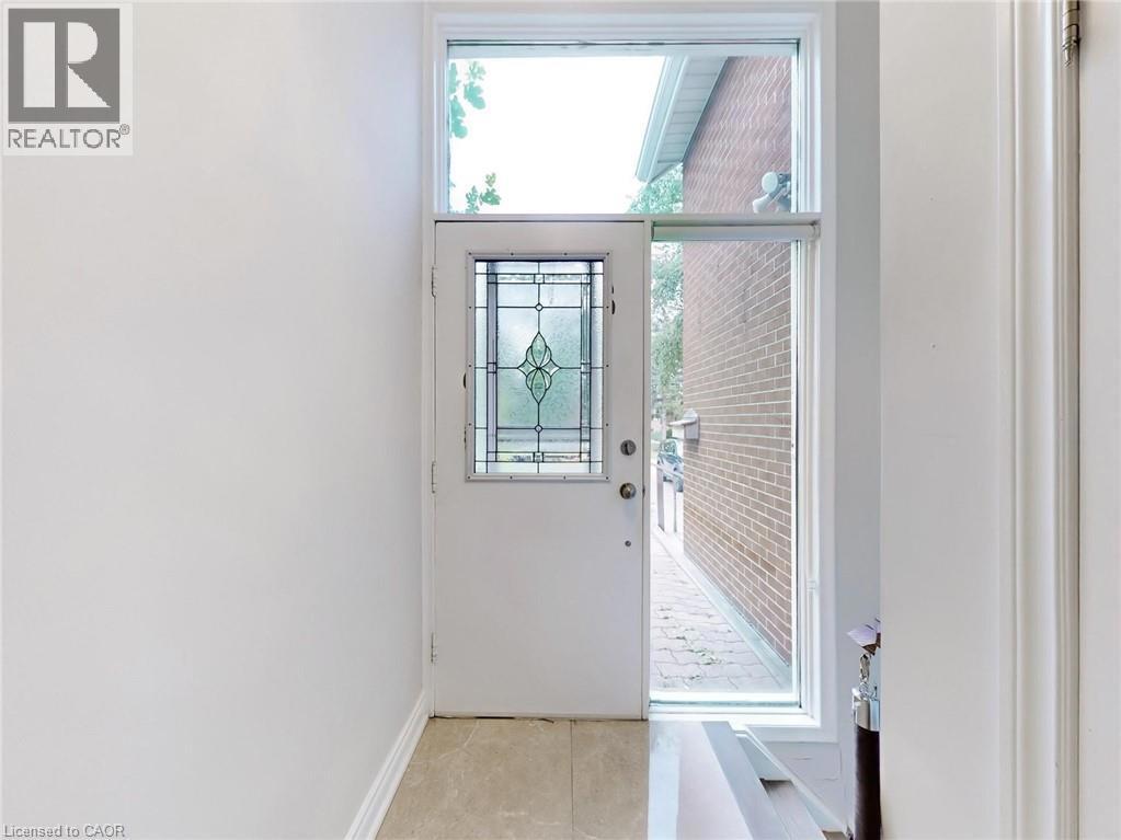 1821 CHRISTOPHER Road=Doorway to outside featuring light tile patterned floors and baseboards